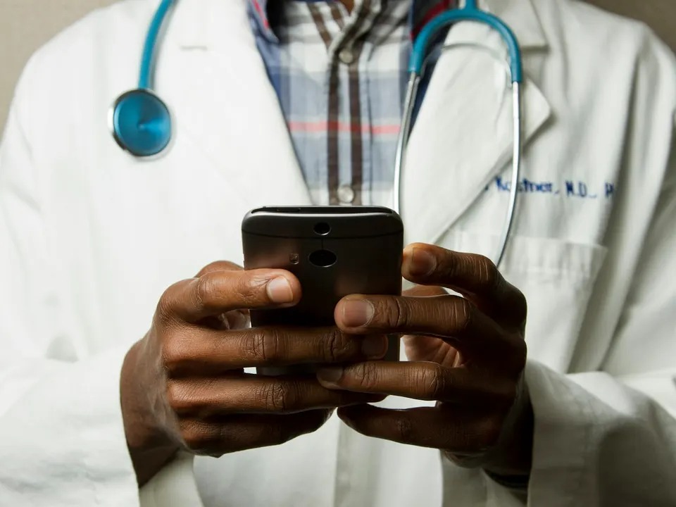 A person talking with a doctor on a video call from home