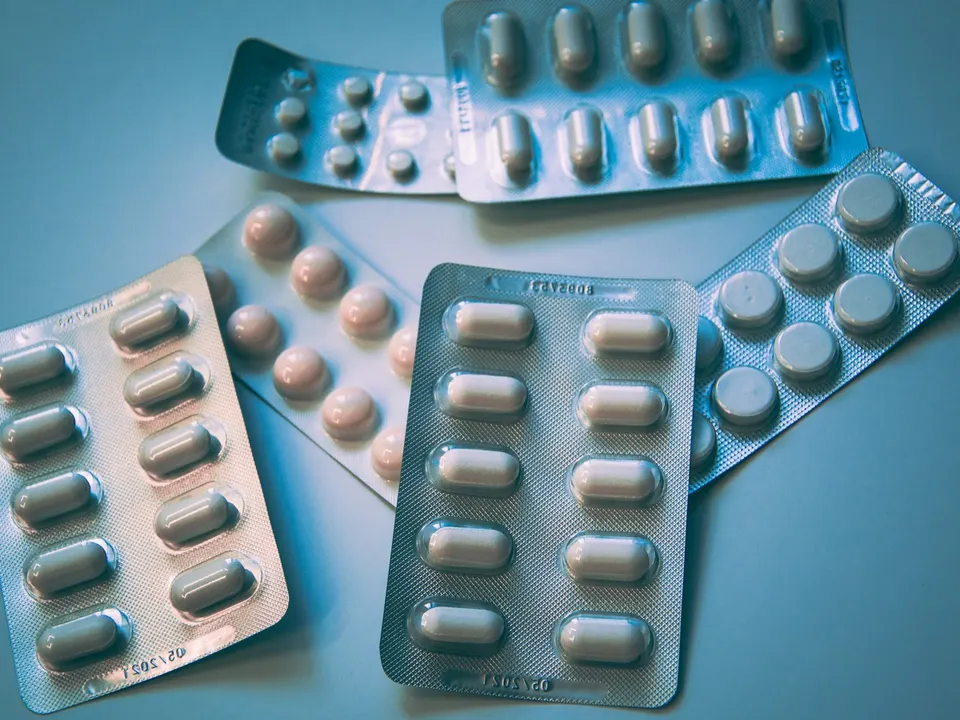 A person reviewing their medications at a kitchen table